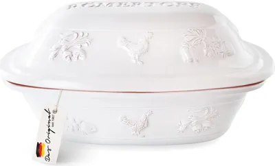 A white ceramic Römertopf (Roman pot) roaster with embossed decorative elements and a tag attached.