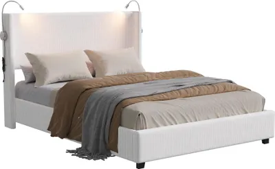 A white upholstered bed with two pillows and bedding, set against a white background.