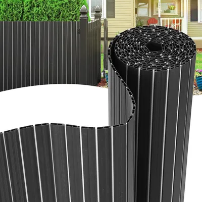 A rolled-up privacy screen fence is shown in the foreground, with a partially unrolled section in the midground, and a fully installed fence in the background.