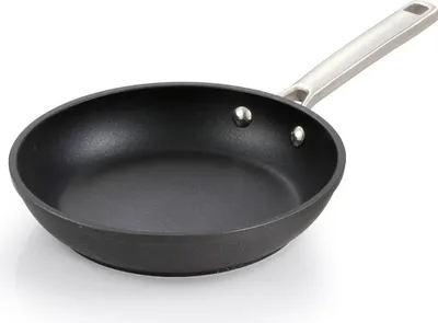 A black frying pan with a silver handle is shown against a white background.