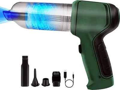 A green and black handheld vacuum cleaner with a transparent dustbin showing a blue swirling vortex of air. Several attachments and a USB charging cable are laid out below the vacuum.