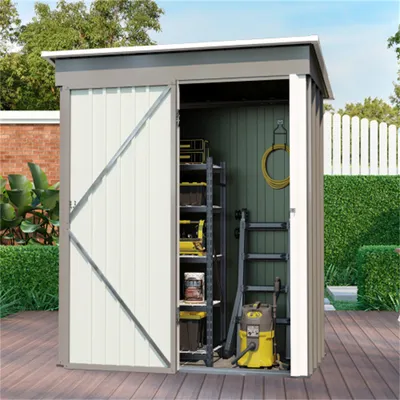 An open garden shed filled with storage shelves, a ladder, and a vacuum cleaner, set on a wooden deck with a white picket fence and greenery in the background.