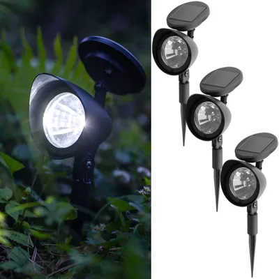 A split image showing a solar-powered garden spotlight in use in a garden on the left, and three such spotlights on a white background on the right.