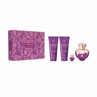 A gift set of Versace Dylan Purple fragrance for women, including a perfume bottle, two lotion tubes, and a miniature perfume bottle, all in purple packaging with a floral pattern.