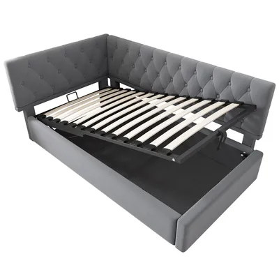 A grey upholstered bed frame with the mattress support pulled out, revealing storage underneath.