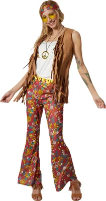 A woman is posing in a full hippie costume.