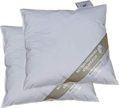 Two white pillows are shown, one slightly behind the other, with a branded band across the front of the top pillow.