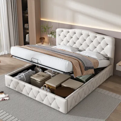 A white upholstered bed with its storage compartment open, revealing various stored items.