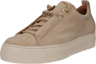 A close-up, studio shot of a single beige sneaker with a thick white sole.