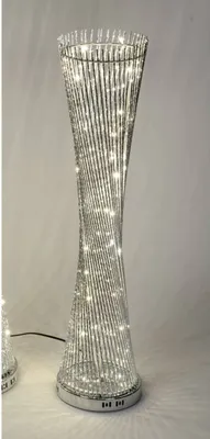 A tall, decorative floor lamp with a twisted design and embedded LED lights.