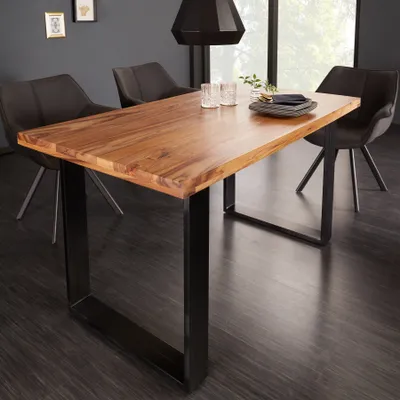 A dining table with chairs in a modern dining room setting.