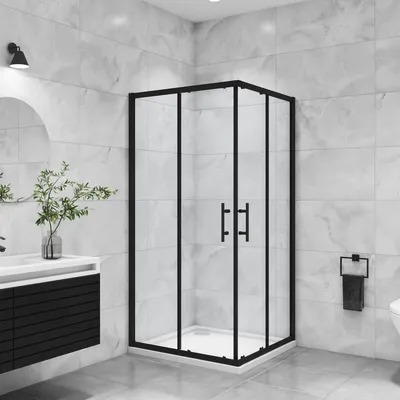 A modern bathroom with a black framed glass shower enclosure.