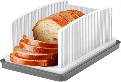 A bread slicer with sliced bread inside, shown from a slightly elevated angle.