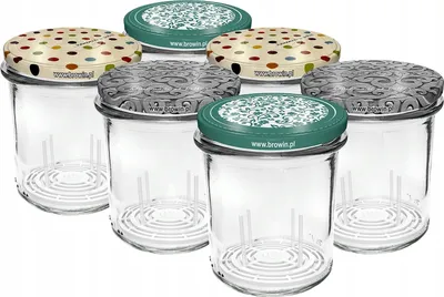 A group of glass jars with decorative lids.
