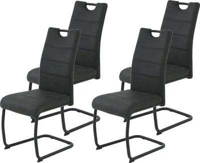 A set of four black dining chairs with metal frames.