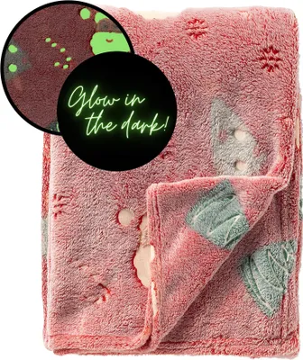 A folded red blanket with a glow-in-the-dark pattern, shown with a close-up inset highlighting the glow-in-the-dark feature and text.