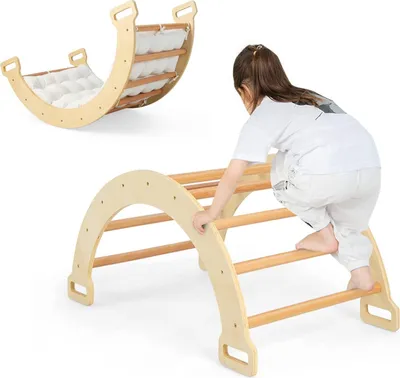 A child is climbing on a wooden climbing arch, with a rocking arch in the background.