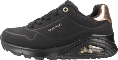 A side view of a black Skechers sneaker with gold accents.