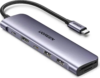 A UGREEN USB-C multifunction adapter is shown from a diagonal angle against a light gray background.