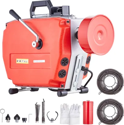A red and gray drain cleaning machine with various accessories laid out below it, including gloves, cables, and different cutting heads.