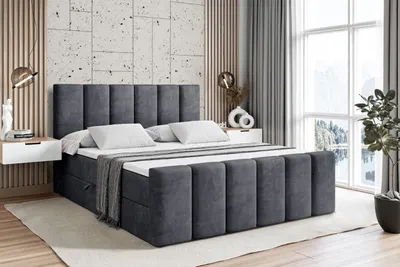 A modern bedroom with a large upholstered bed.