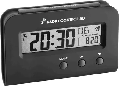 A black digital alarm clock with a clear display showing the time and alarm settings.