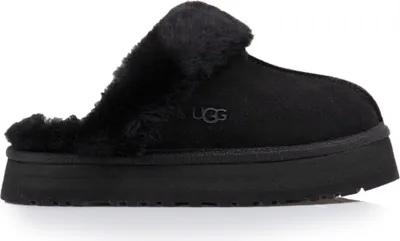 A black UGG slipper with fluffy lining is shown against a white background.