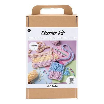 A cardboard box containing a crochet starter kit for making small bags.
