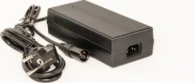 A black power adapter with cables and connectors is shown against a white background.