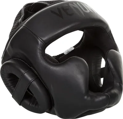 A black Venum boxing headguard is shown from the side against a white background.