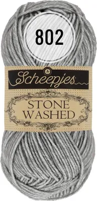 A ball of grey and white yarn with a label.