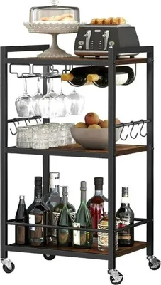 A multi-tiered serving cart filled with various items like bottles, glasses, a toaster, and fruit.