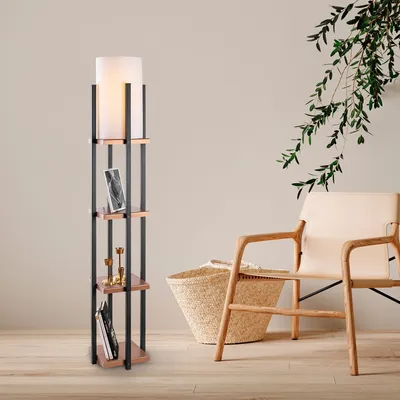 A floor lamp with shelves is placed next to a chair and a basket in a room.