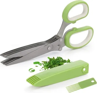 A set of herb scissors, a green herb stripper, and chopped herbs on a white background.