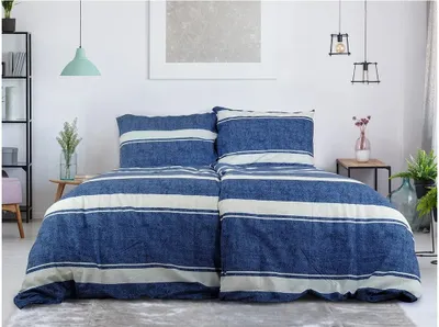 A neatly made bed with blue and white striped bedding.