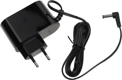 A black power adapter with a coiled black cord and a right-angled connector.