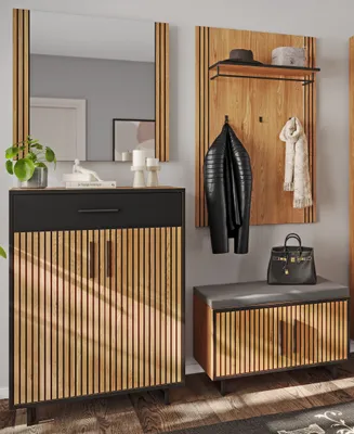 A modern entryway with a mirror, shoe cabinet, and coat rack.