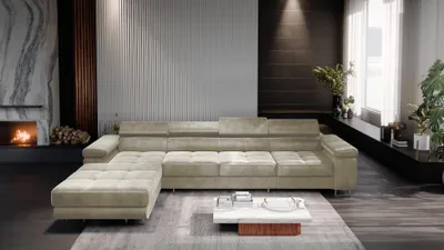 A modern living room with a large sectional sofa, fireplace, and decorative elements.