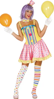 A woman dressed in a colorful clown costume, holding balloons.