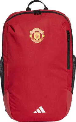 A red backpack with the Manchester United logo and Adidas logo.