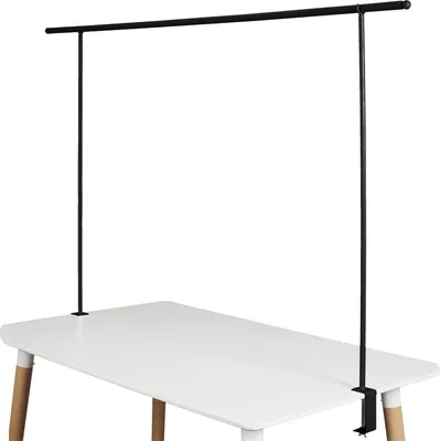 A black metal table clamp and rod assembly is mounted on a white table.