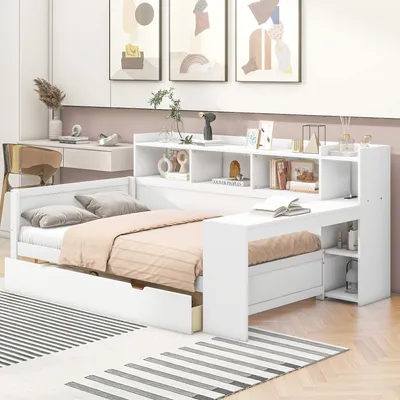 A white daybed with a built-in desk and shelving unit, set up in a bedroom with decorative artwork on the wall.