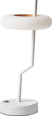 A white table lamp with a unique ring-shaped shade and a zig-zag stem.