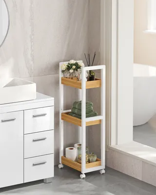A bathroom scene with a white vanity and a rolling storage cart.