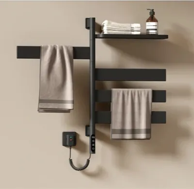 A black electric towel warmer with towels and a soap dispenser on a shelf.