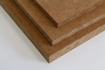 A stack of three pieces of MDF board.