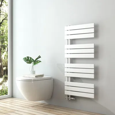 A modern bathroom with a wall-mounted toilet and a white towel radiator.