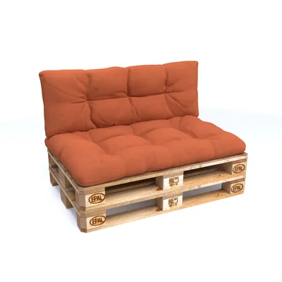 A pallet sofa with orange cushions on a white background.