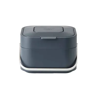 A dark gray compost bin with a silver handle against a white background.