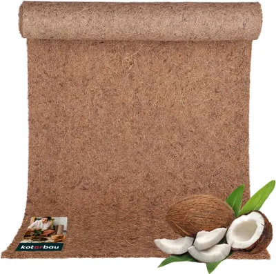 A rolled-up coconut mat with coconuts and leaves in the foreground.